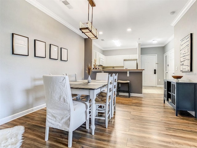 1361 Tuscan Ter Unit 7303, Davenport, FL 33896 - dining room featuring ornamental molding, light wood finished floors, and recessed lighting