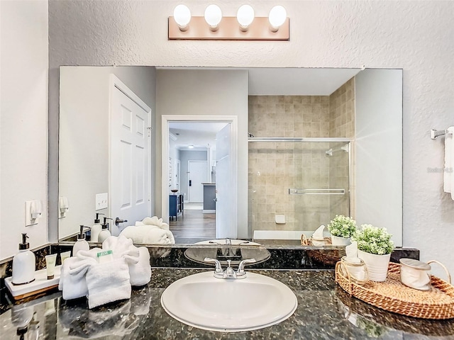 1361 Tuscan Ter Unit 7303, Davenport, FL 33896 - full bath featuring a shower stall, a textured wall, and vanity