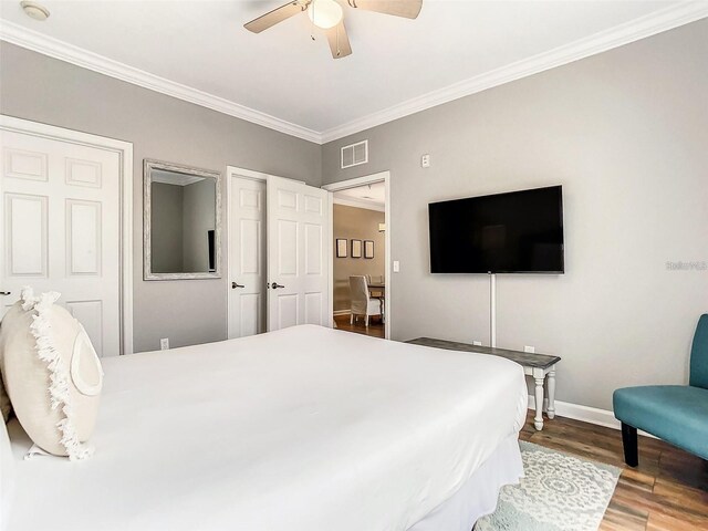 1361 Tuscan Ter Unit 7303, Davenport, FL 33896 - bedroom featuring ornamental molding, wood finished floors, ceiling fan, and multiple closets