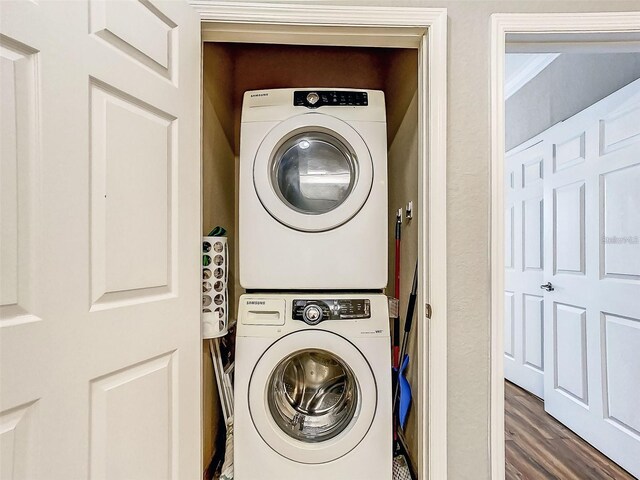 1361 Tuscan Ter Unit 7303, Davenport, FL 33896 - laundry area with stacked washer and clothes dryer and wood finished floors