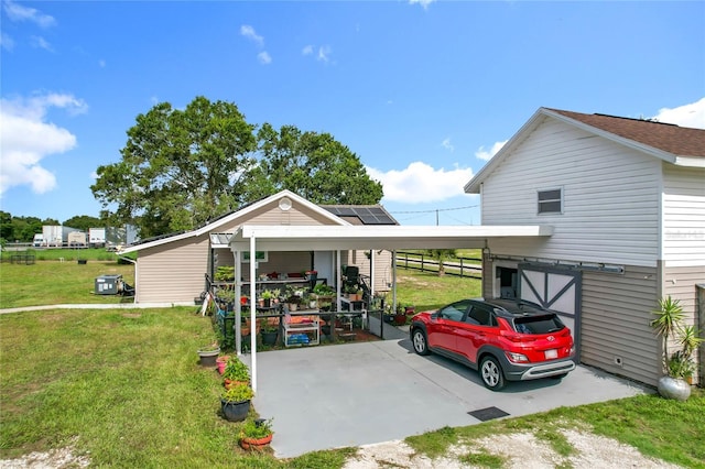 view of front facade with a front lawn, a carport, and driveway