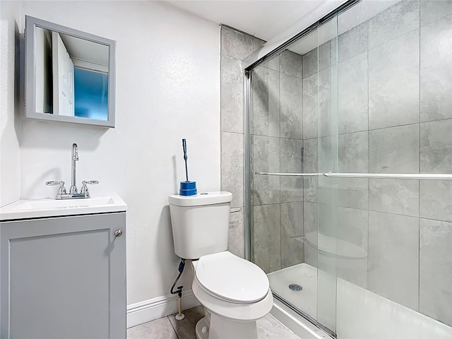 full bath with vanity, a stall shower, and tile patterned flooring