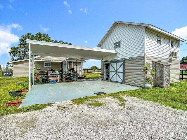 exterior space featuring a carport, cooling unit, and covered porch