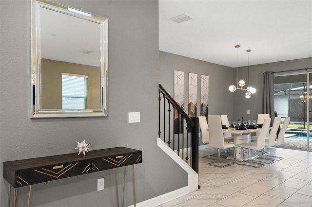 4547 Narrative Ln, Kissimmee, FL 34746 - stairway featuring a chandelier and baseboards