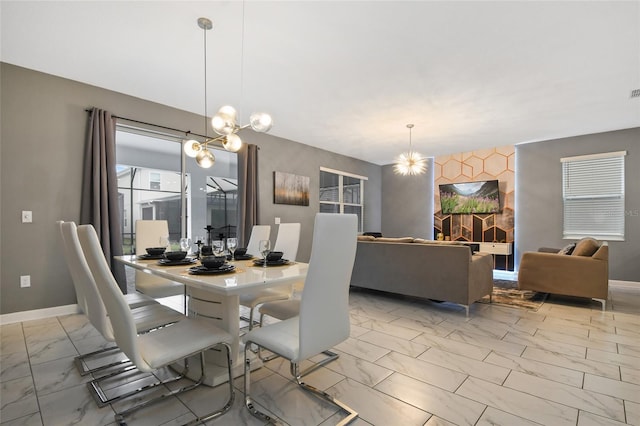 4547 Narrative Ln, Kissimmee, FL 34746 - dining room featuring a chandelier and light marble finish flooring