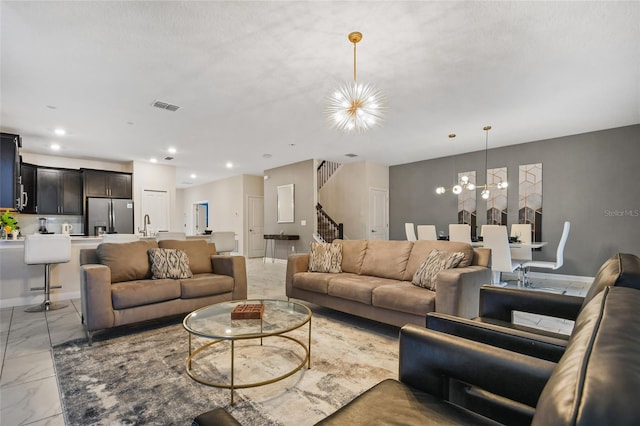 4547 Narrative Ln, Kissimmee, FL 34746 - living area featuring a chandelier, light marble finish floors, stairs, and recessed lighting