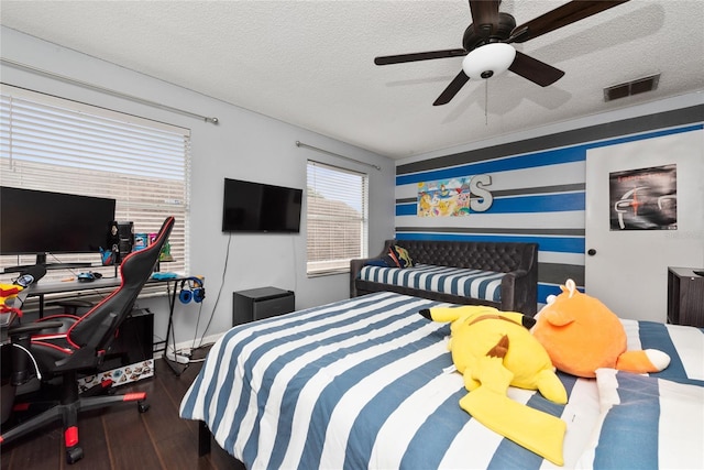13129 Cog Hill Way, Orlando, FL 32828 - bedroom with a textured ceiling, wood finished floors, a desk, and a ceiling fan