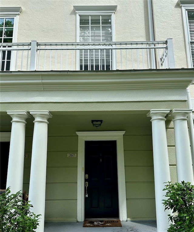 267 Goldenrain Dr Unit 30, Celebration, FL 34747 - property entrance featuring a balcony, covered porch, and stucco siding