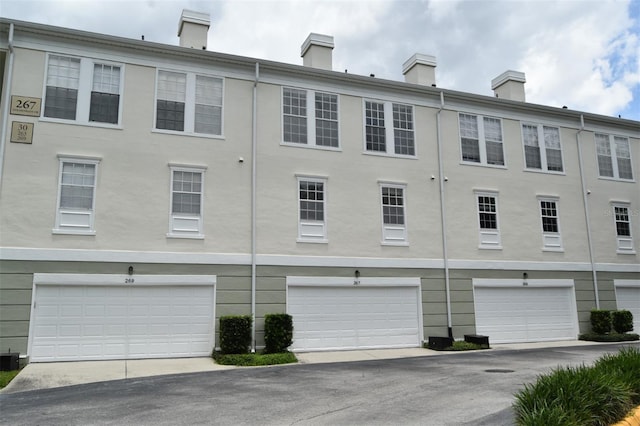 267 Goldenrain Dr Unit 30, Celebration, FL 34747 - view of property featuring a garage and driveway