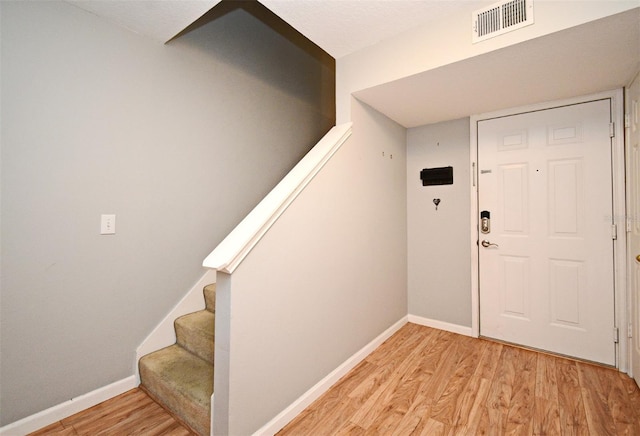 267 Goldenrain Dr Unit 30, Celebration, FL 34747 - entrance foyer with light wood-style flooring and stairs