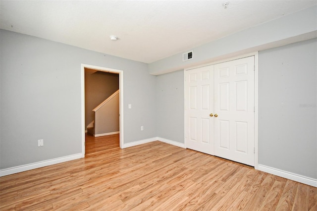 267 Goldenrain Dr Unit 30, Celebration, FL 34747 - unfurnished bedroom featuring light wood finished floors and a closet