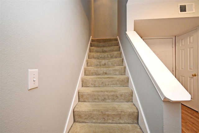 267 Goldenrain Dr Unit 30, Celebration, FL 34747 - stairs featuring wood finished floors and a textured wall