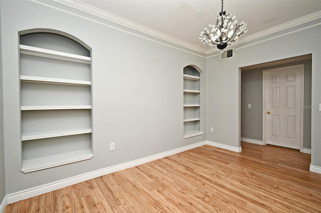 267 Goldenrain Dr Unit 30, Celebration, FL 34747 - empty room with built in features, wood finished floors, ornamental molding, and a chandelier
