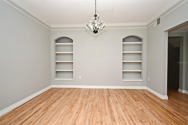267 Goldenrain Dr Unit 30, Celebration, FL 34747 - unfurnished room with built in features, wood finished floors, a chandelier, and ornamental molding