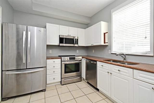 267 Goldenrain Dr Unit 30, Celebration, FL 34747 - kitchen with stainless steel appliances, white cabinets, and dark countertops