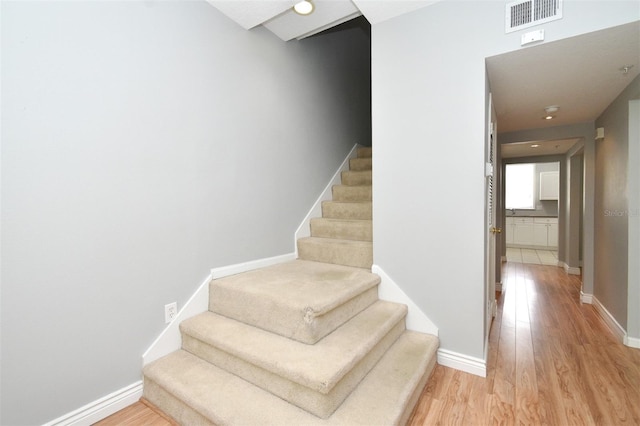 267 Goldenrain Dr Unit 30, Celebration, FL 34747 - staircase featuring wood finished floors and baseboards