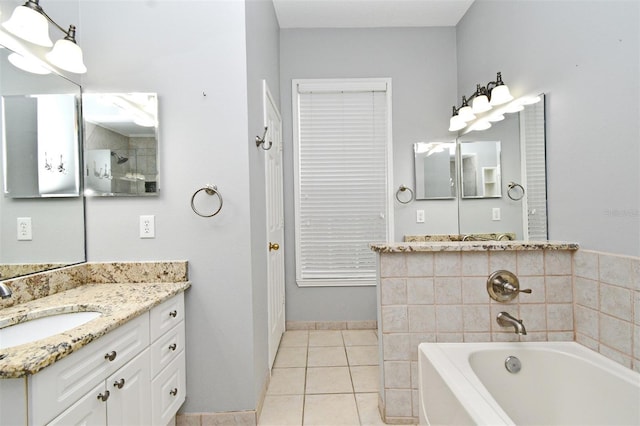 267 Goldenrain Dr Unit 30, Celebration, FL 34747 - bathroom featuring a garden tub, vanity, and tile patterned floors