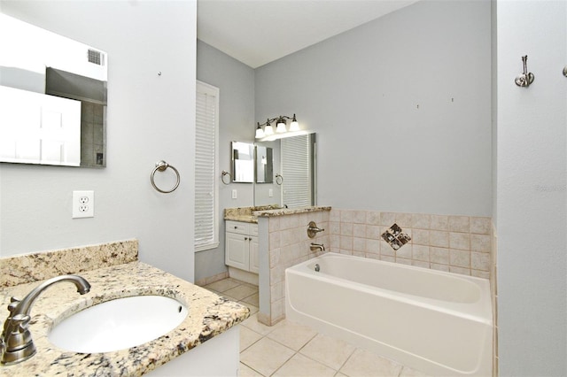 267 Goldenrain Dr Unit 30, Celebration, FL 34747 - bathroom featuring tile patterned floors, a bath, and two vanities