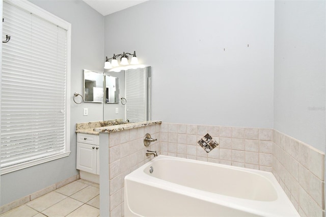 267 Goldenrain Dr Unit 30, Celebration, FL 34747 - full bathroom featuring vanity, a bath, and tile patterned floors