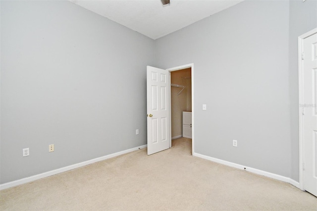 267 Goldenrain Dr Unit 30, Celebration, FL 34747 - unfurnished bedroom featuring light colored carpet and a walk in closet