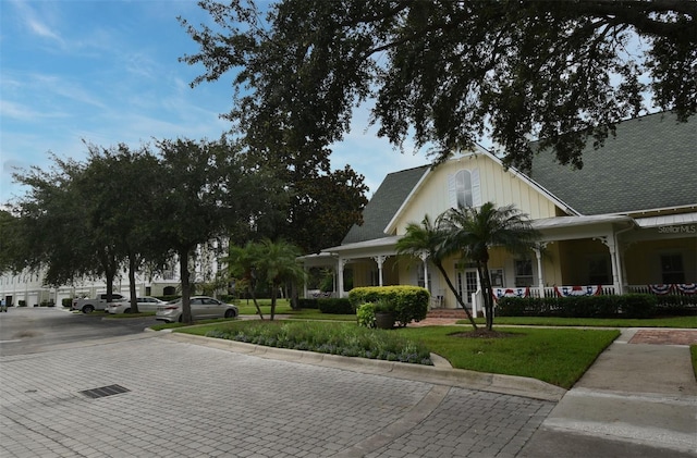 267 Goldenrain Dr Unit 30, Celebration, FL 34747 - view of front facade featuring a porch and a front yard