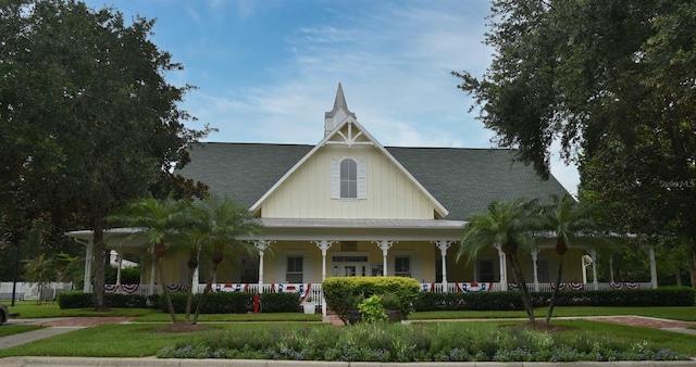 267 Goldenrain Dr Unit 30, Celebration, FL 34747 - view of front of property with a porch, a front yard, and board and batten siding