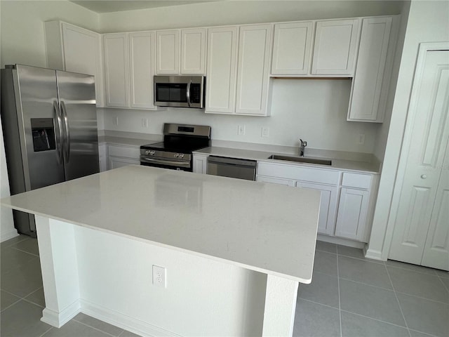 2626 Skyline Loop, Kissimmee, FL 34758 - kitchen with stainless steel appliances, light tile patterned flooring, white cabinetry, and light countertops