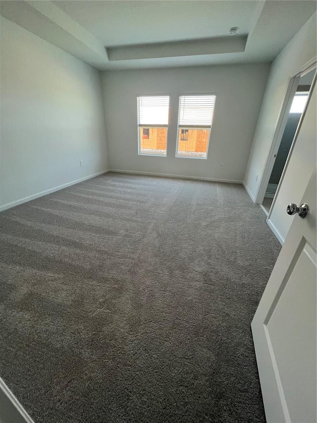 2626 Skyline Loop, Kissimmee, FL 34758 - empty room with a tray ceiling and carpet