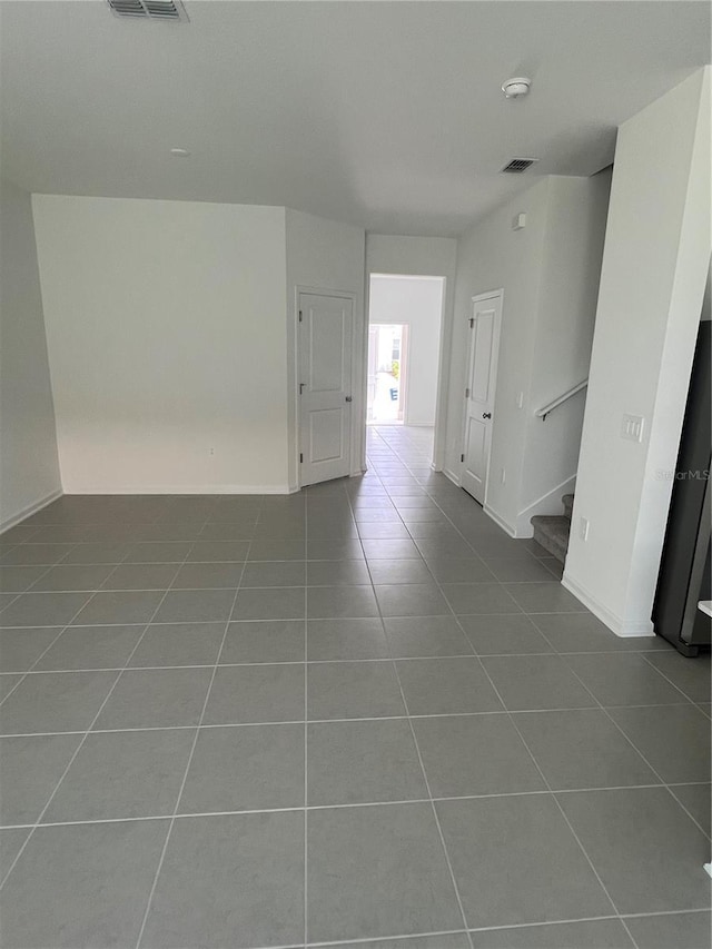 2626 Skyline Loop, Kissimmee, FL 34758 - spare room with tile patterned flooring, a smoke detector, and stairway