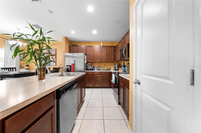 739 Jefferson, Davenport, FL 33837 - kitchen featuring stainless steel appliances, light countertops, recessed lighting, light tile patterned floors, and a textured ceiling