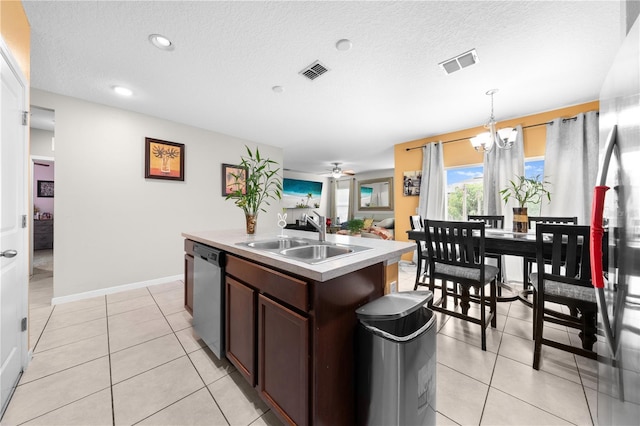 739 Jefferson, Davenport, FL 33837 - kitchen featuring stainless steel dishwasher, a kitchen island with sink, pendant lighting, light countertops, and a textured ceiling