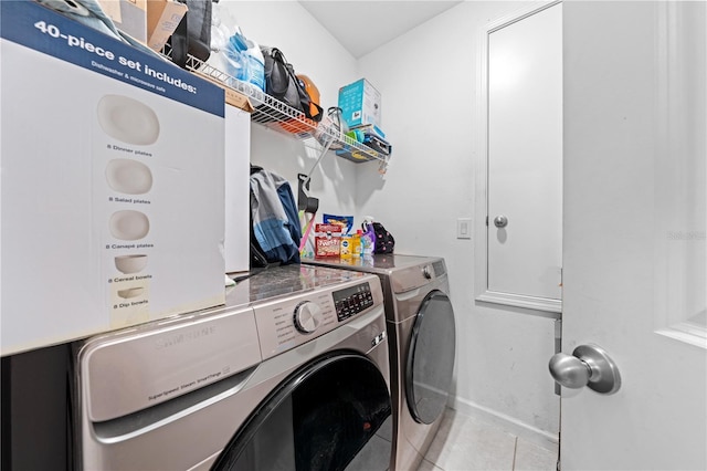 739 Jefferson, Davenport, FL 33837 - laundry area with washing machine and clothes dryer and tile patterned flooring