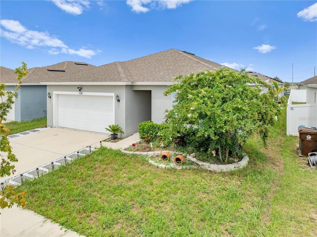 739 Jefferson, Davenport, FL 33837 - ranch-style home featuring a shingled roof, an attached garage, driveway, stucco siding, and a front lawn