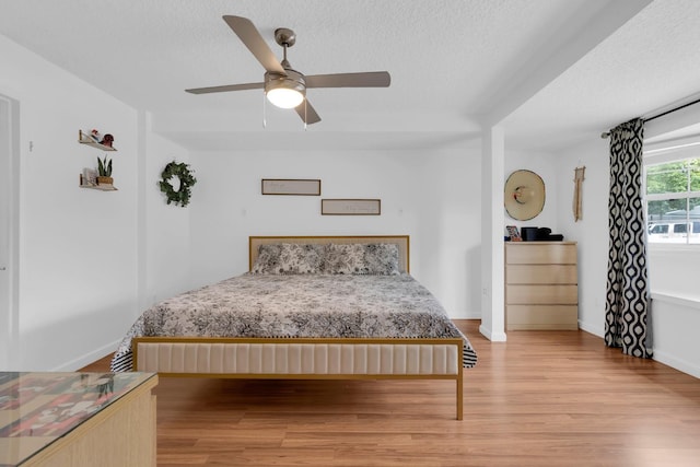 1710 Thor Ave, Apopka, FL 32703 - bedroom featuring light wood-style flooring, a textured ceiling, and ceiling fan