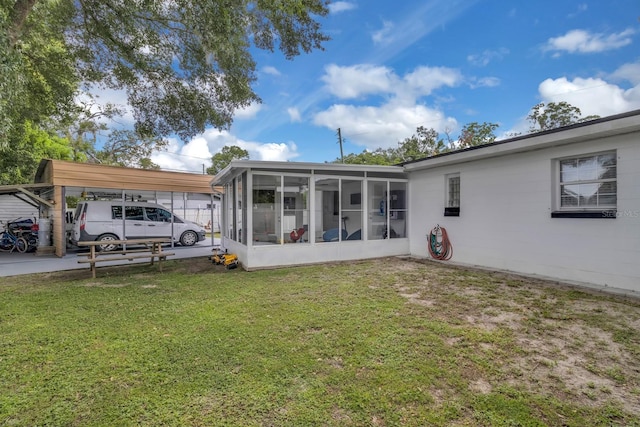 1710 Thor Ave, Apopka, FL 32703 - back of property featuring a sunroom, a lawn, and a detached carport