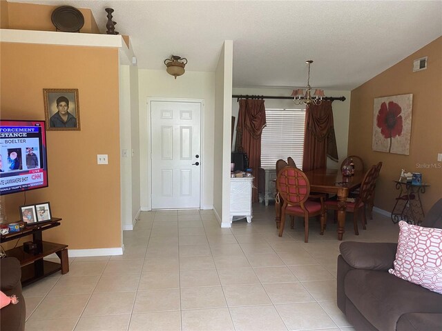 13327 Caspian Ln, Clermont, FL 34711 - living room with a chandelier, light tile patterned floors, and lofted ceiling