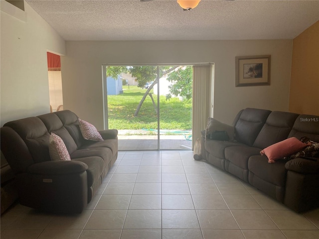 13327 Caspian Ln, Clermont, FL 34711 - living room with light tile patterned flooring and a textured ceiling