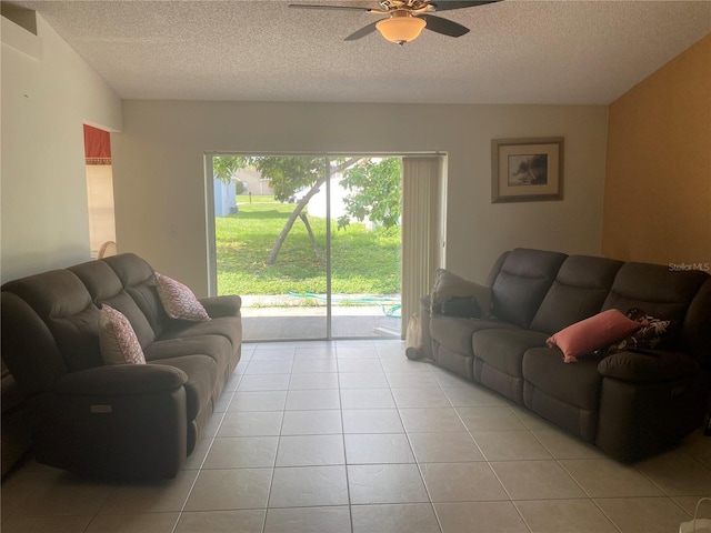 13327 Caspian Ln, Clermont, FL 34711 - living room featuring ceiling fan, light tile patterned flooring, and a textured ceiling