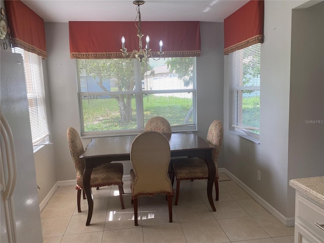 13327 Caspian Ln, Clermont, FL 34711 - dining space featuring a chandelier, healthy amount of natural light, and light tile patterned flooring