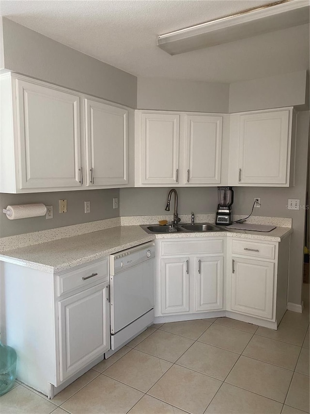 13327 Caspian Ln, Clermont, FL 34711 - kitchen featuring white dishwasher, white cabinets, light tile patterned floors, and light countertops