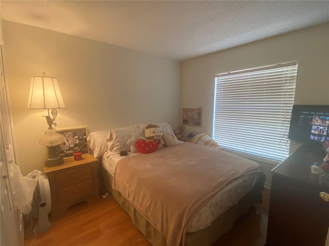 13327 Caspian Ln, Clermont, FL 34711 - bedroom featuring light wood finished floors and a textured ceiling