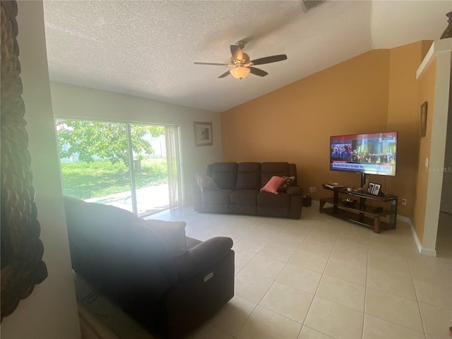 13327 Caspian Ln, Clermont, FL 34711 - living room with lofted ceiling, a ceiling fan, a textured ceiling, and light tile patterned flooring