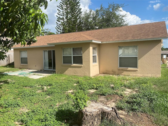 13327 Caspian Ln, Clermont, FL 34711 - back of property with stucco siding and a shingled roof