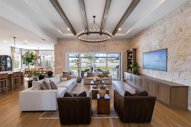 9352 Santorini Dr, Orlando, FL 32827 - living room featuring beamed ceiling, healthy amount of natural light, wood finished floors, recessed lighting, and a chandelier