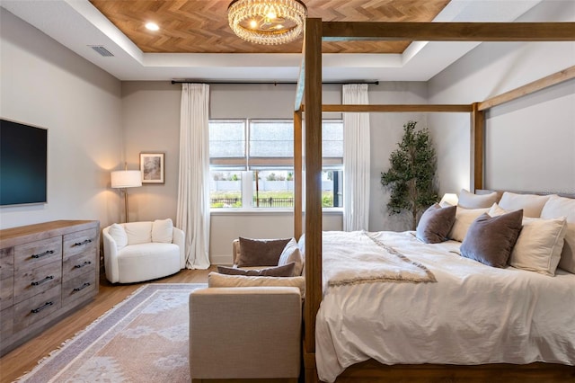 9352 Santorini Dr, Orlando, FL 32827 - bedroom featuring a raised ceiling, wood finished floors, and a chandelier