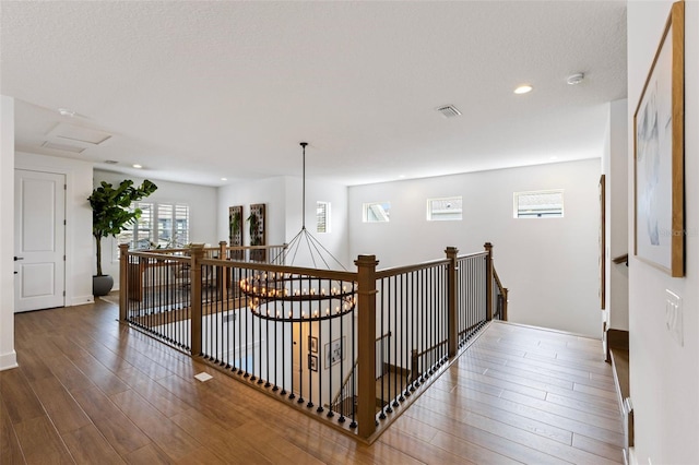 9352 Santorini Dr, Orlando, FL 32827 - hallway featuring an upstairs landing, wood finished floors, and recessed lighting