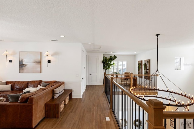 9352 Santorini Dr, Orlando, FL 32827 - corridor featuring an upstairs landing, wood finished floors, recessed lighting, and a textured ceiling