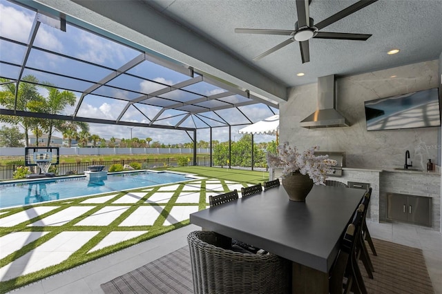 9352 Santorini Dr, Orlando, FL 32827 - view of swimming pool with an outdoor kitchen, a ceiling fan, a patio area, and glass enclosure