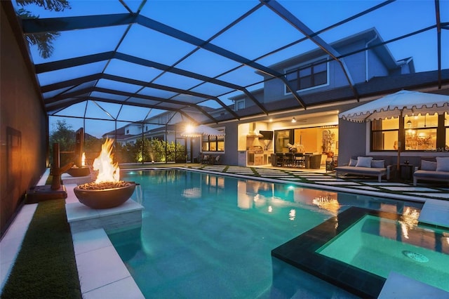 9352 Santorini Dr, Orlando, FL 32827 - view of pool featuring a patio area, a pool with connected hot tub, a lanai, and an outdoor living space with a fire pit