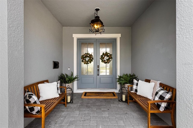 9352 Santorini Dr, Orlando, FL 32827 - property entrance with french doors and stucco siding